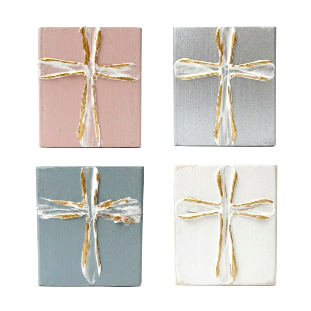 Decorative wood blocks with gold and white crosses on a white background