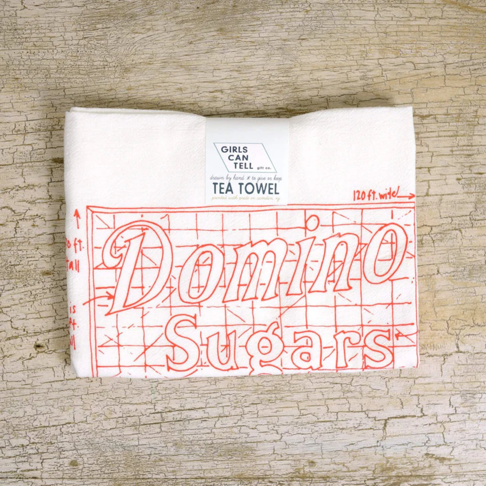 Tea towel with 'Domino Sugars' text on a wooden surface