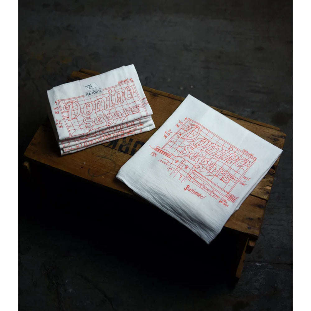 White towels with red text and graphics on a wooden surface