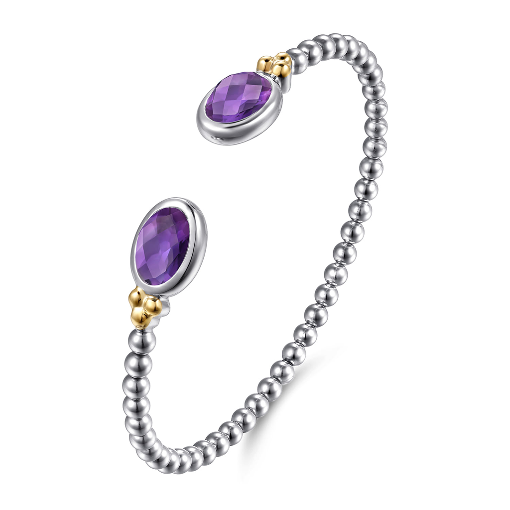 Silver beaded bracelet with purple gemstones on a white background
