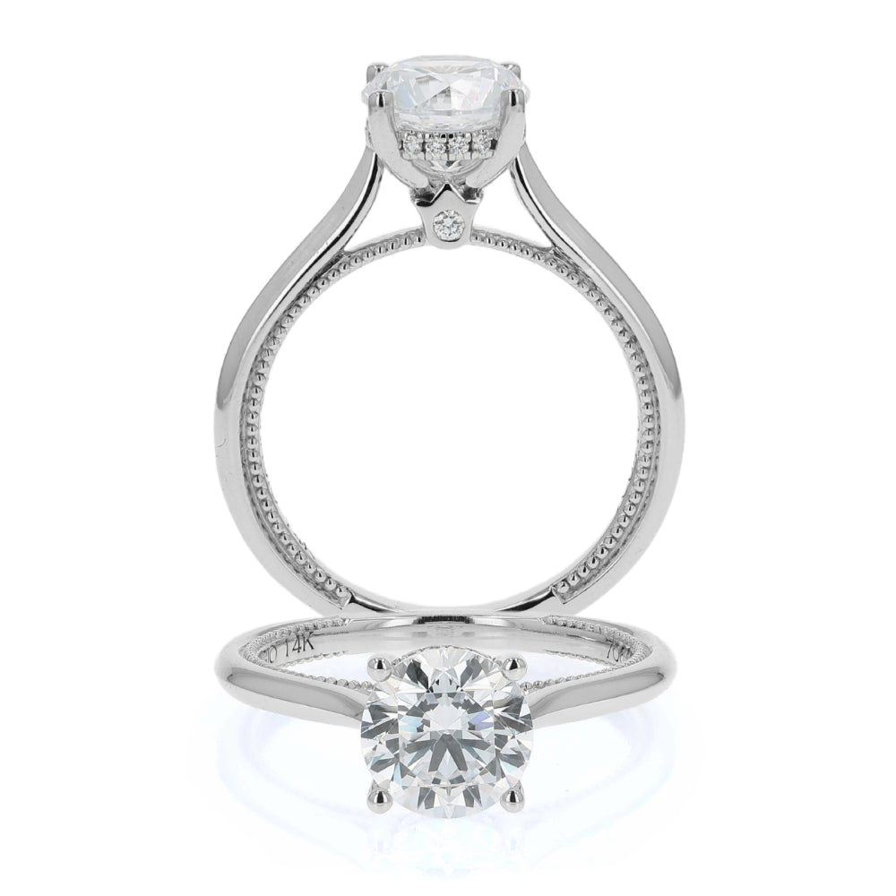 Silver ring with two diamond-like stones on a white background