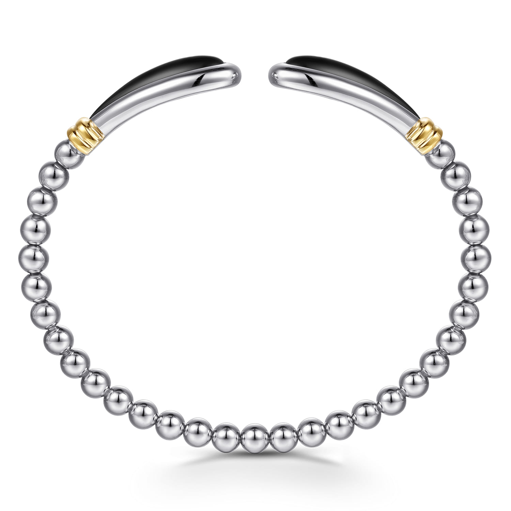 Silver bracelet with gold accents on a white background