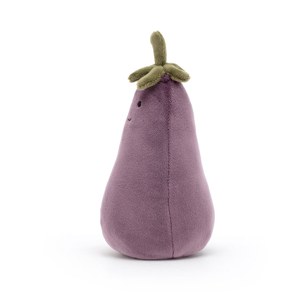  The side of a small plush toy resembling an aubergine with a smiling face, made from soft fabric with a green stalk on top.