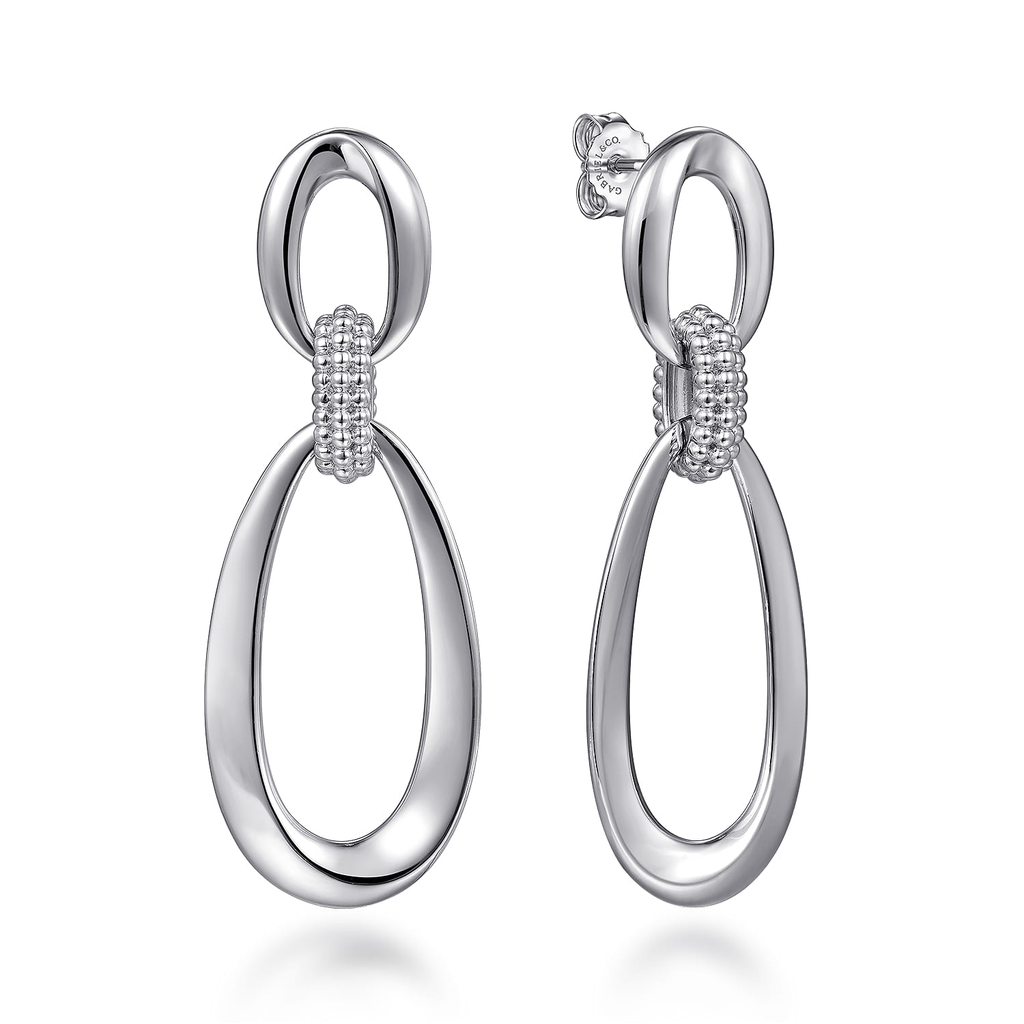 Silver earrings with a design on a white background