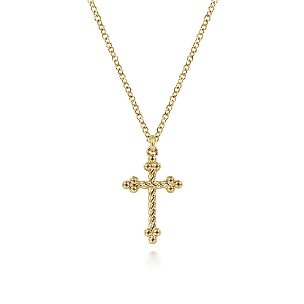 Gold cross necklace on a white background