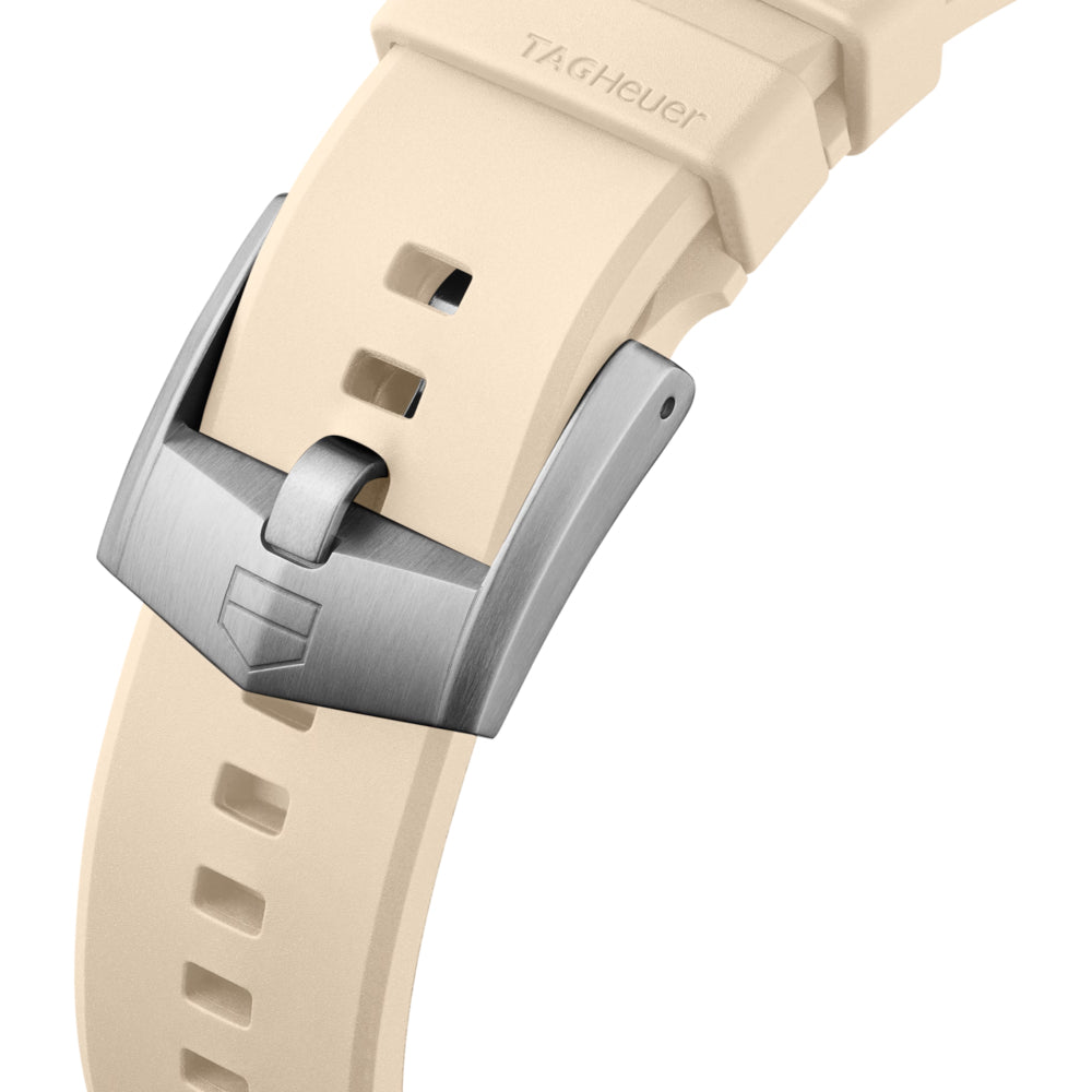 Beige watch strap with silver buckle on a white background
