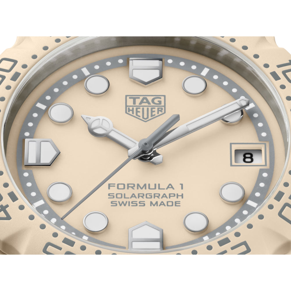 Tag Heuer watch with beige face and silver accents on a white background