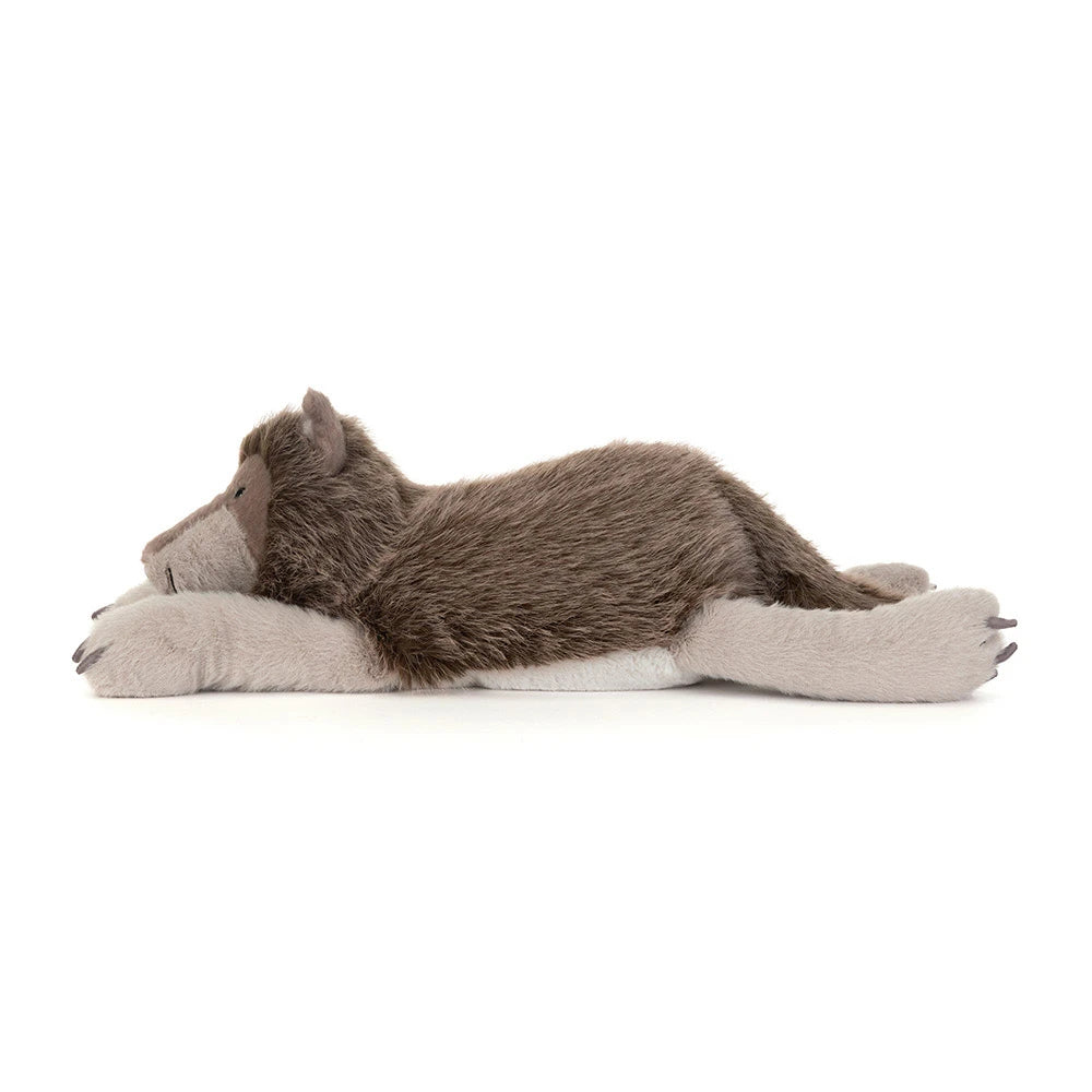 A plush stuffed animal shaped like a sleeping wolf or coyote, lying on its side with long gray paws extended, photographed on a clean white background.