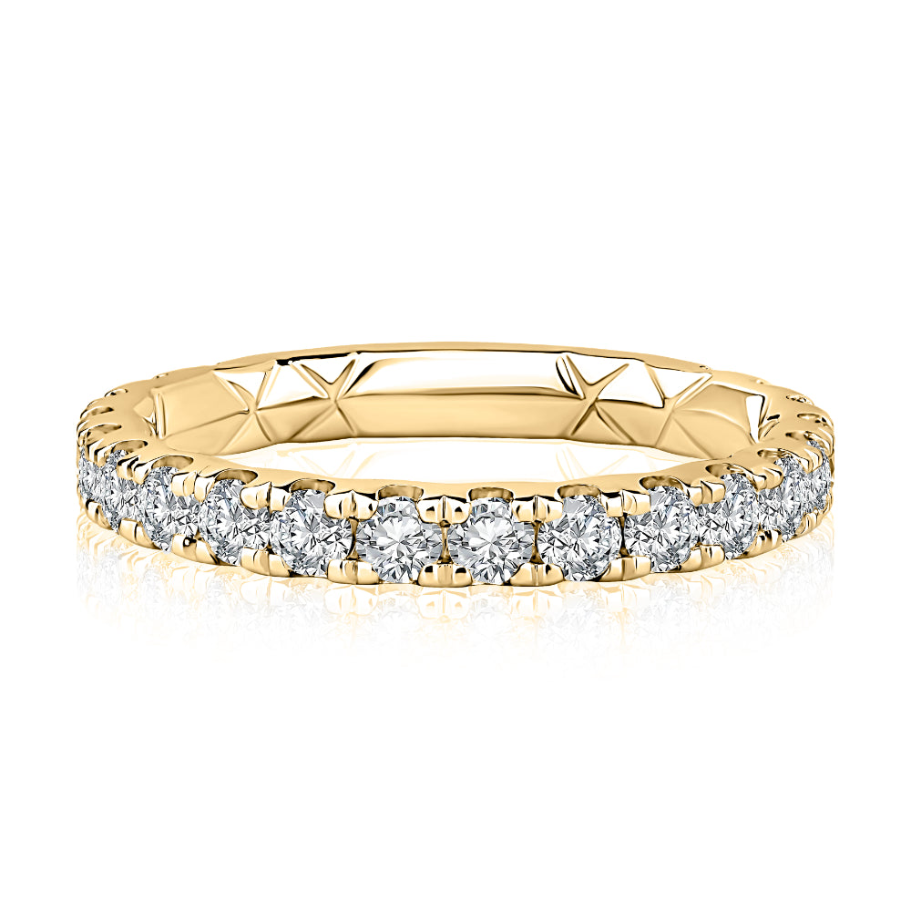 Gold ring with diamond stones on a white background