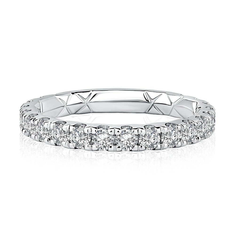 Silver ring with diamond accents on a white background