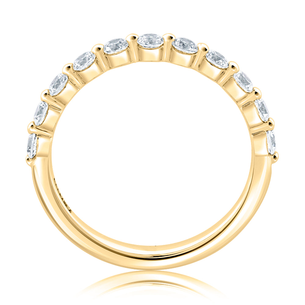 Gold ring with embedded diamonds on a white background