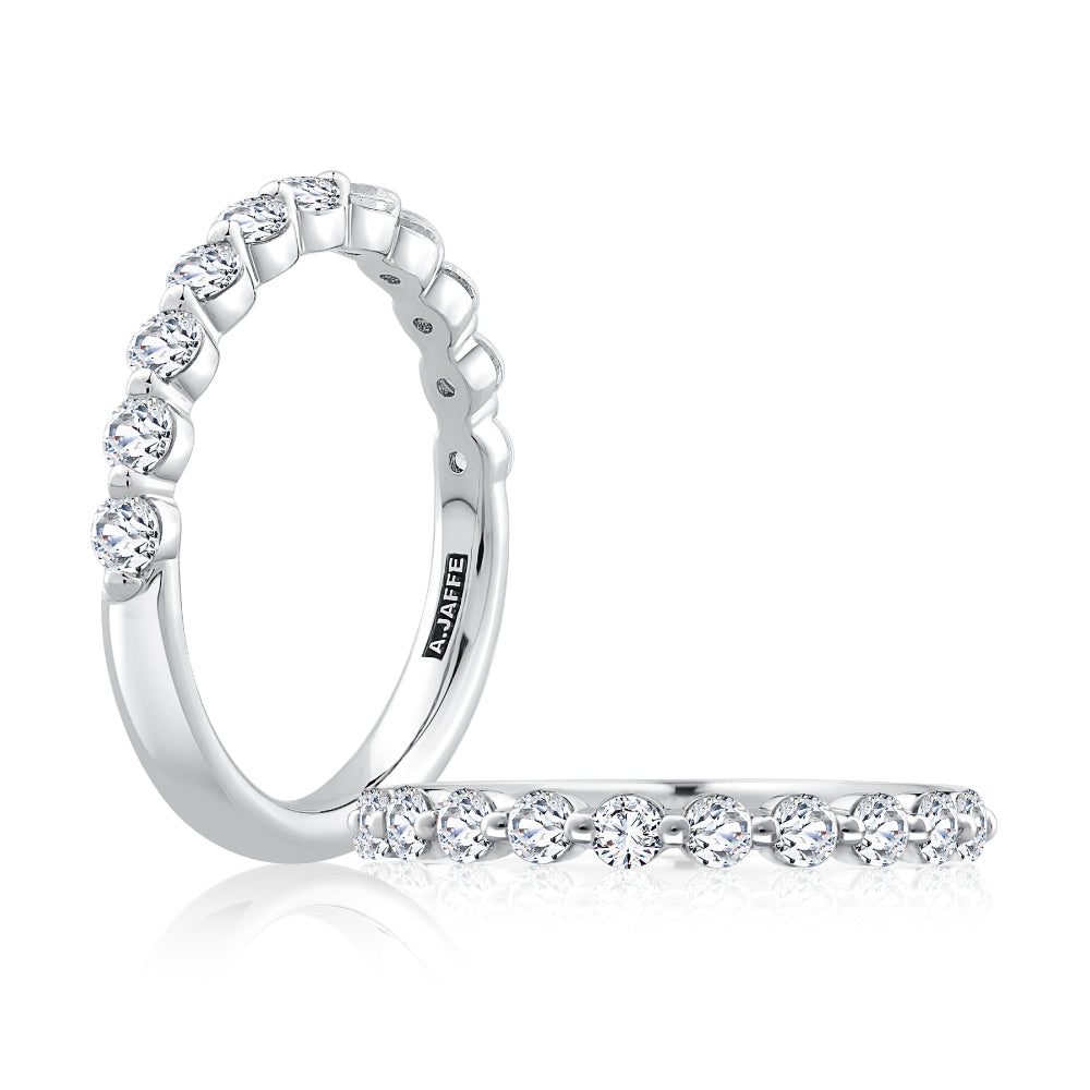 Silver ring with diamond accents on a white background