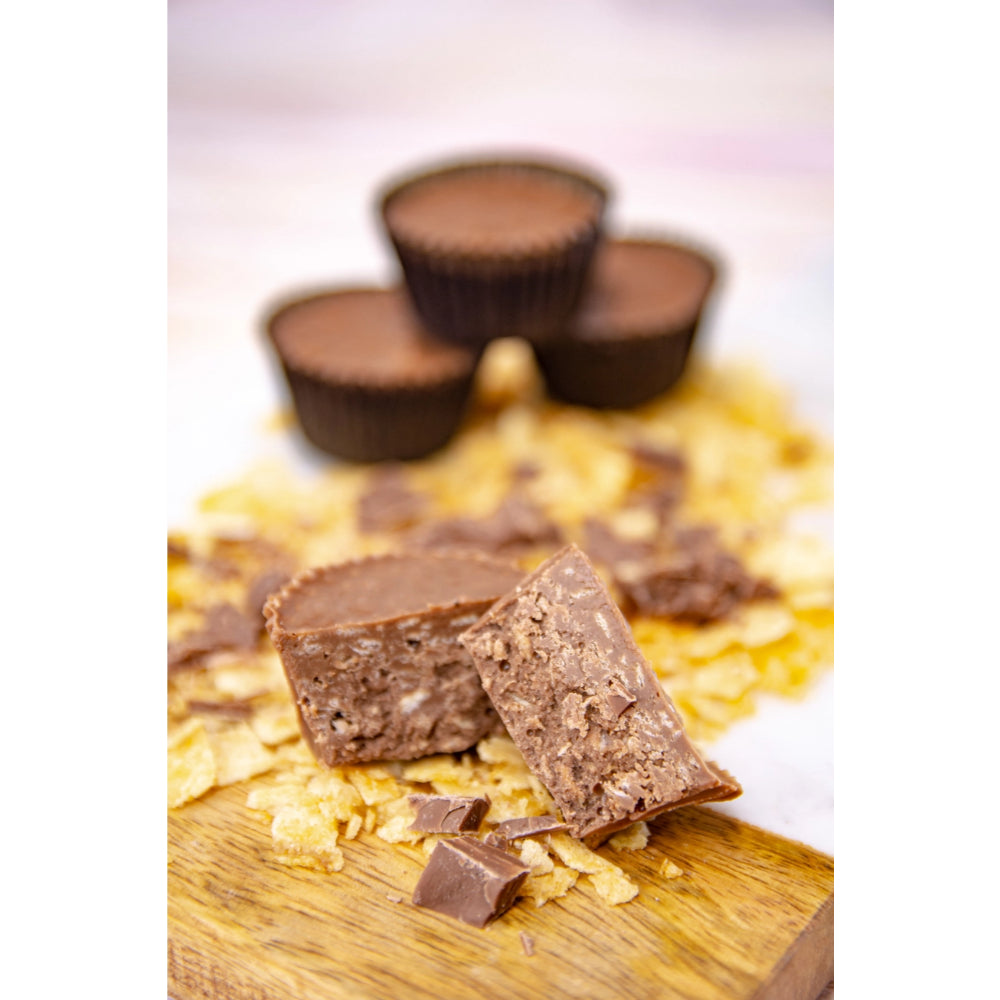 Wockenfuss Candies Milk Chocolate Crab Potato Chip Clusters on a board with patato chips. 