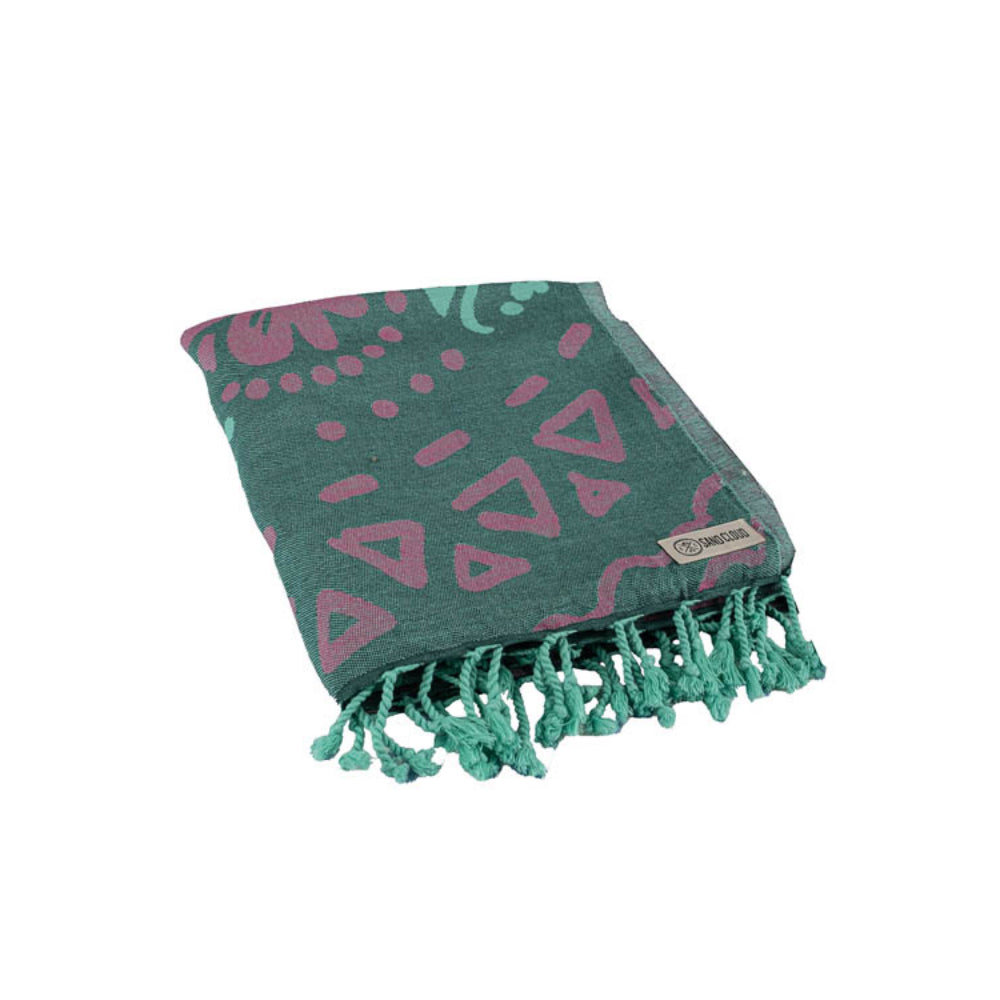 Green towel with pink geometric patterns and green tassel edge on a white background.