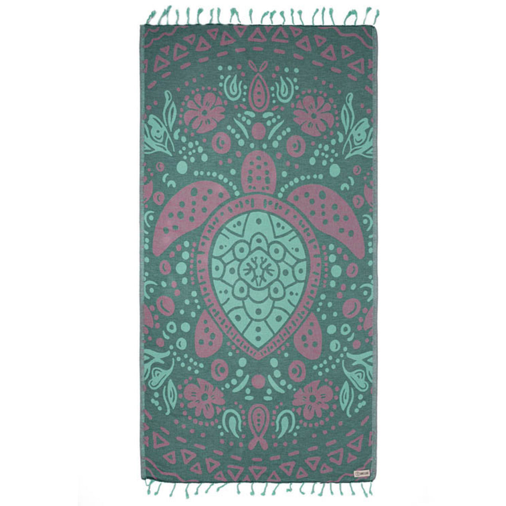 Side one of  beach towel with a turtle design in teal, green & pink with a green tassel edge on a white background.