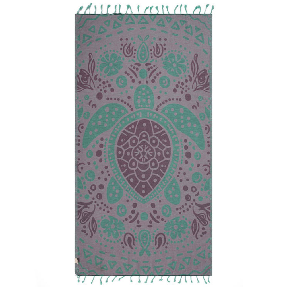Side two of  beach towel with a turtle design in green & pink with a green tassel edge on a white background.