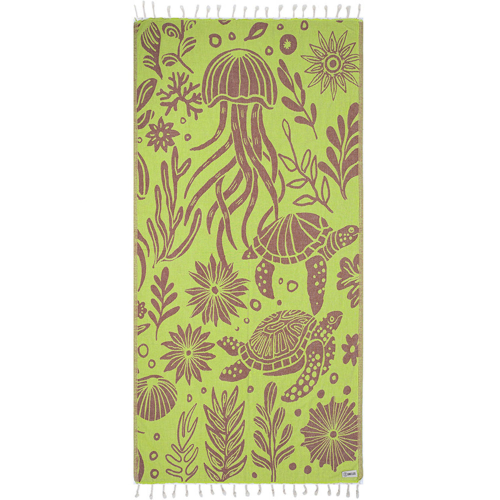 Side one of a green and brown towel with brown sea turtle and jellyfish pattern with a white tassel edge on a white background.