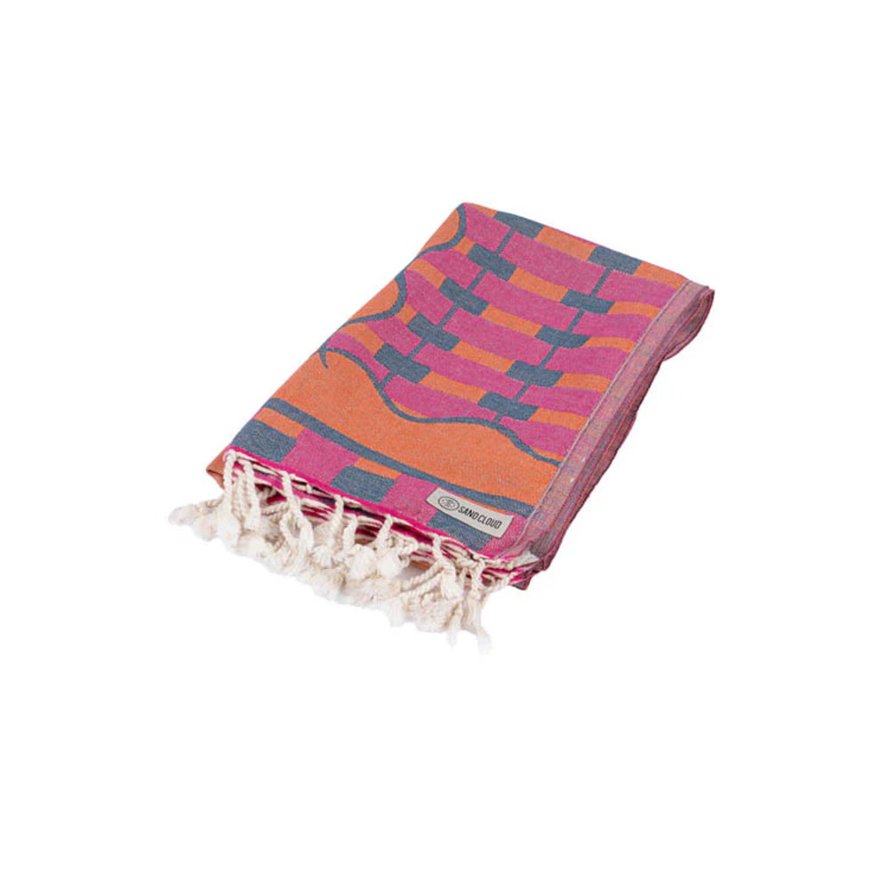 Colorful patterned towel with tassels folded on a white background.