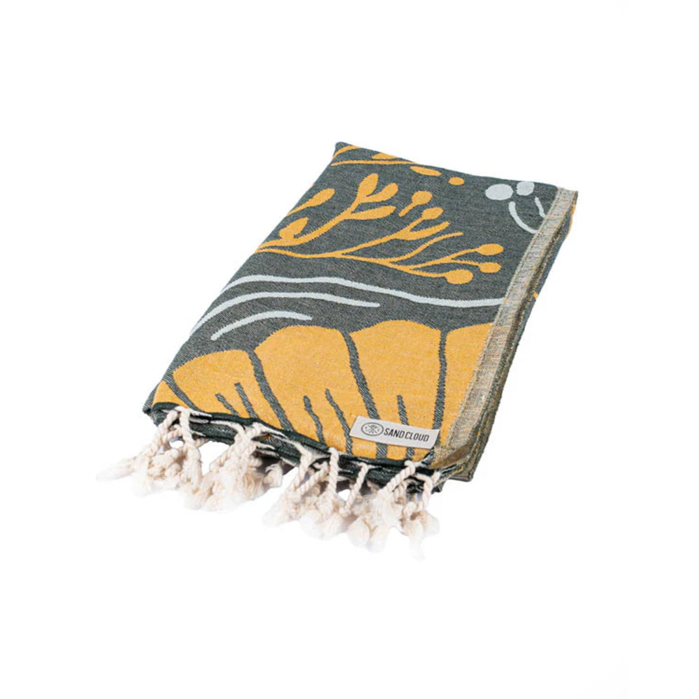 Foldee beach Towel with a gold and blue design and white tassels on a white background.