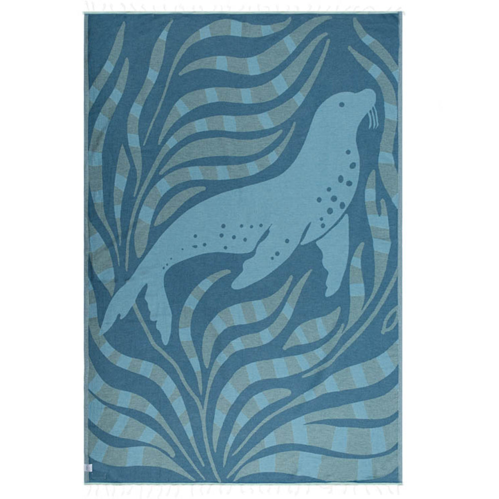 Side two of a blue beach towel with two reversible patterns with a seal design and blue wavy patterns on a white background.
