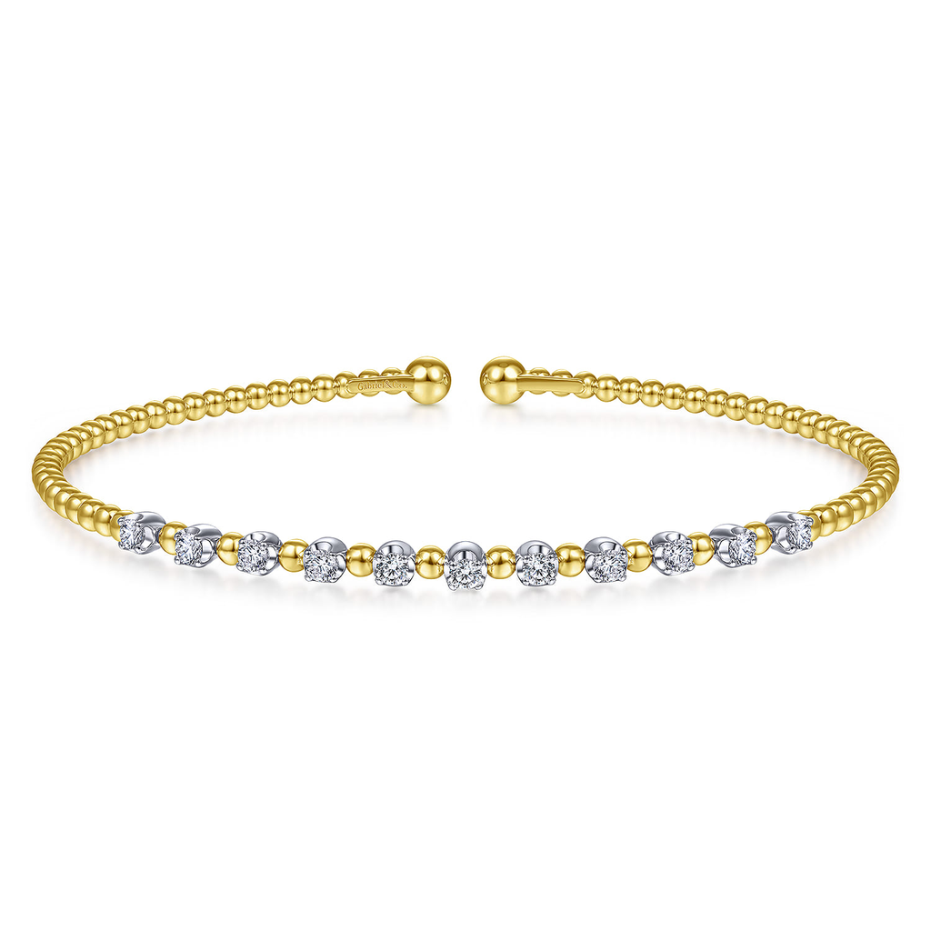 yellow bracelet with clear stone stations on white background