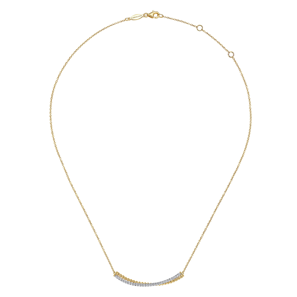 gold and silver bar necklace pendant with clear stones on white background