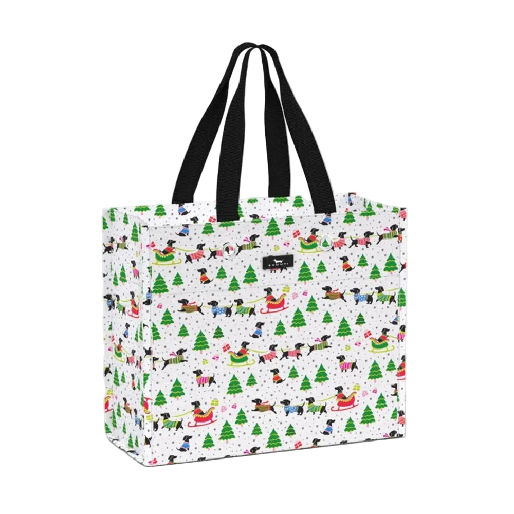 A white tote bag with a festive Christmas dog print, featuring black webbed handles and a small black brand label on the front.