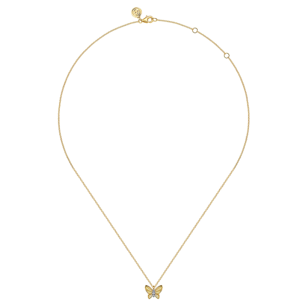 gold butterfly pendant on white background