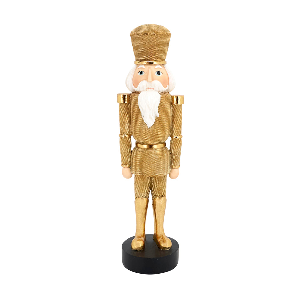 A gold metallic nutcracker soldier figurine with a white beard, standing on a black base against a plain white background.