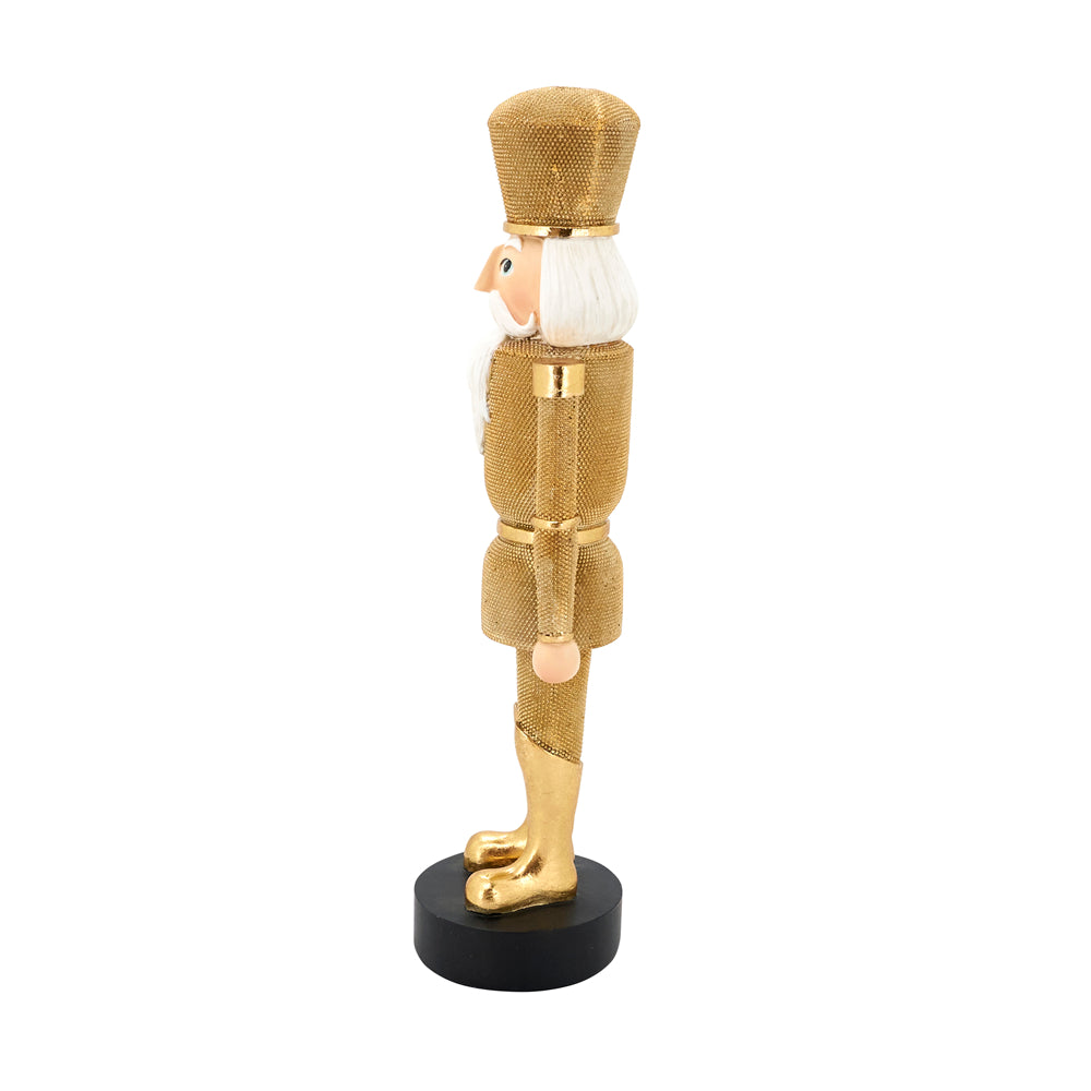 A gold-finished nutcracker figurine with a white beard and hat, standing on a round black base against a plain white background.