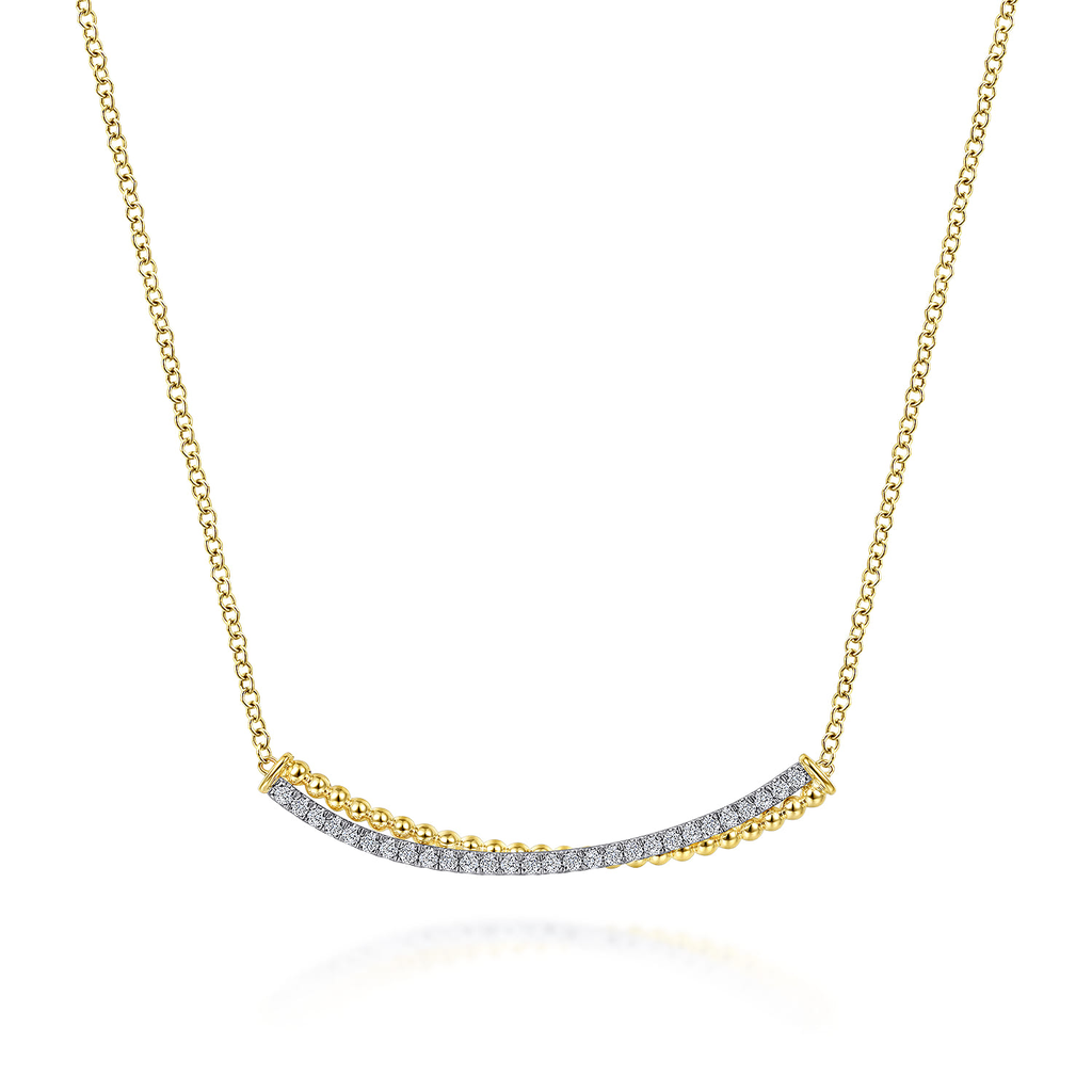 gold and silver bar necklace pendant with clear stones on white background