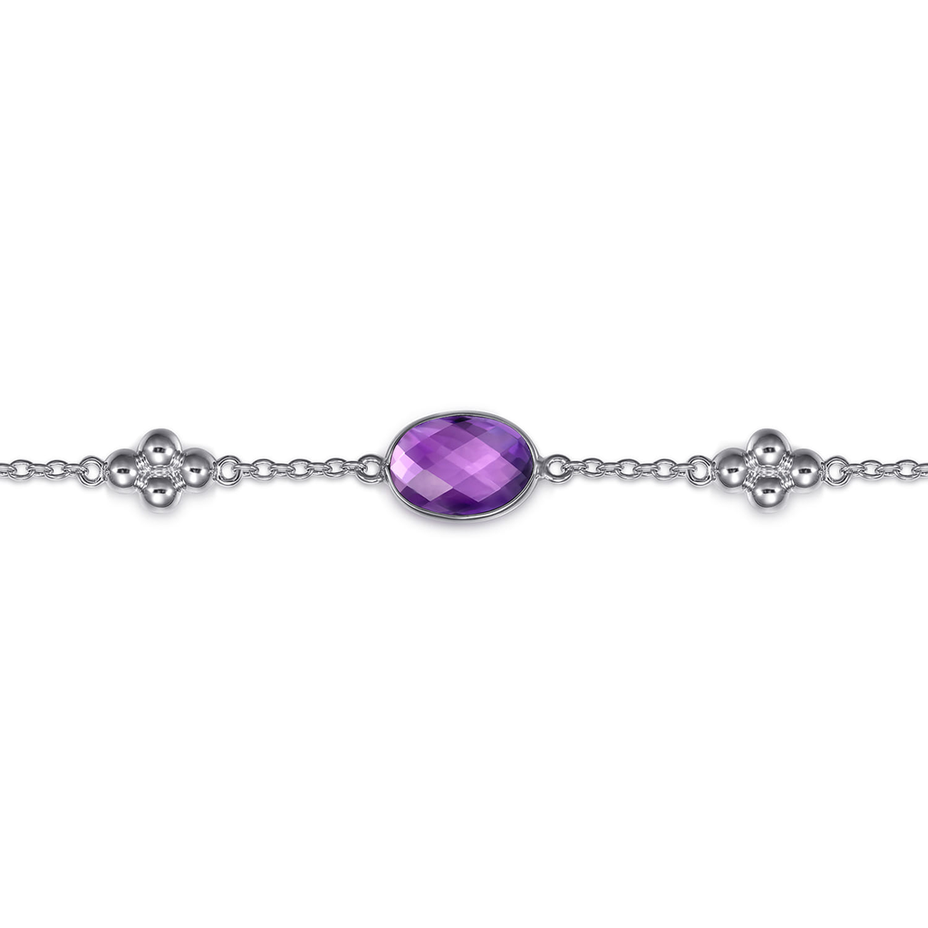 silver bracelet with purple stone on white background