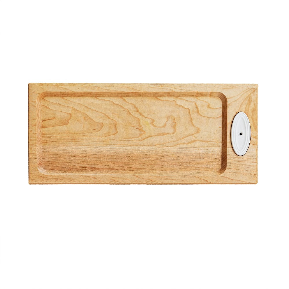 Wooden cutting board with a white circular ceramic piece with hole on a white background