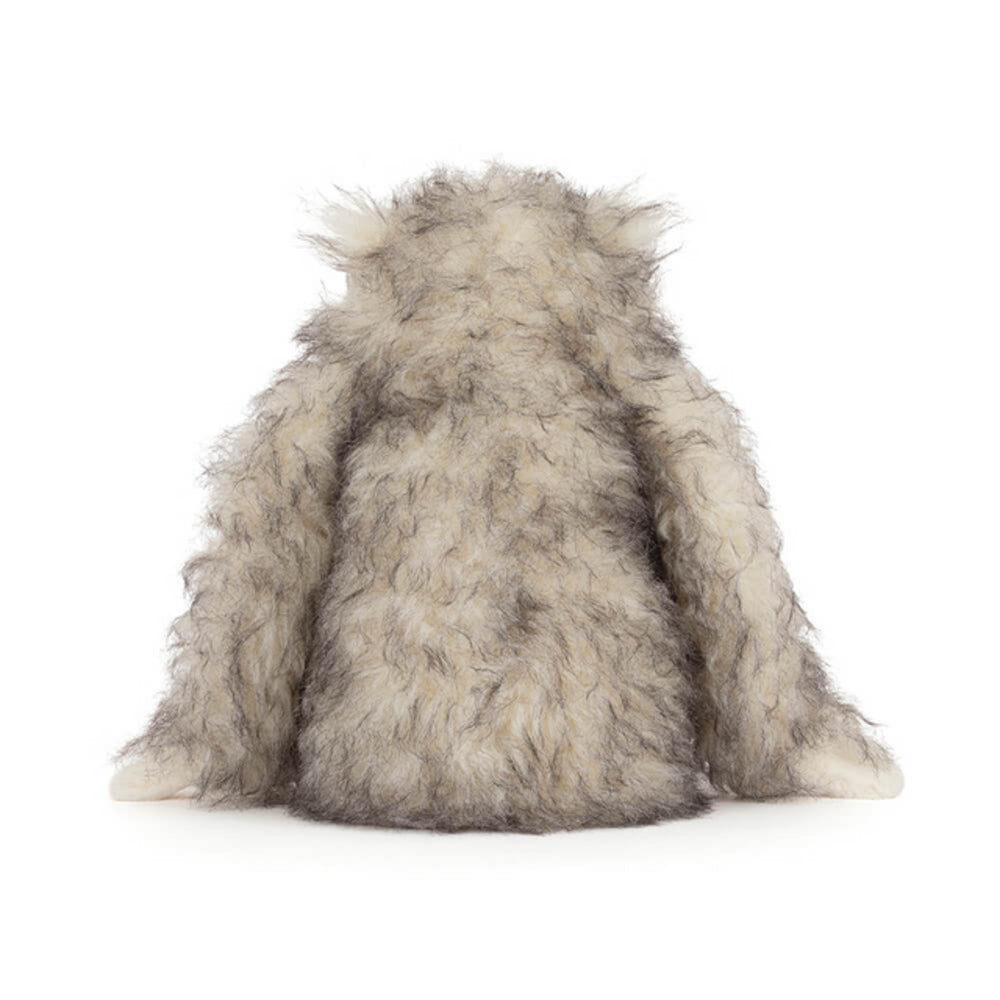 A  photo of the back of a plush toy Bretti Yeti with gray and white fur on a white background.