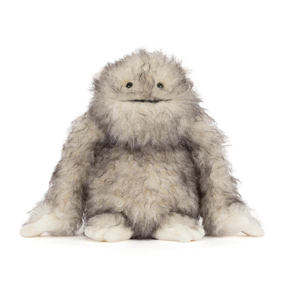A front photo of a plush toy Bretti Yeti with gray and white fur on a white background.