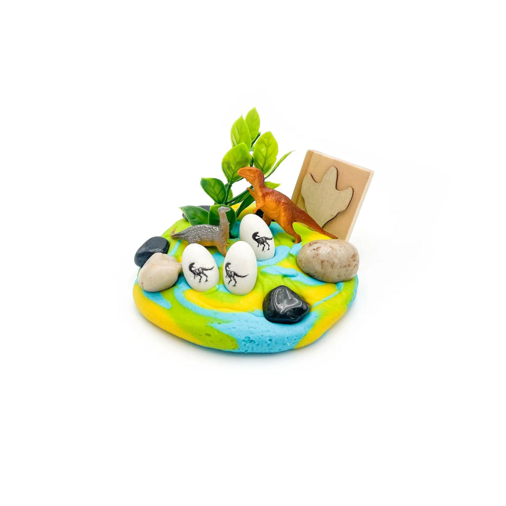 Miniature diorama with a dinosaur, eggs, and plants on a colorful base.