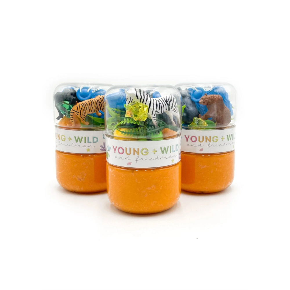 Three small jars with animal figurines and 'Young & Wild' label on a white background