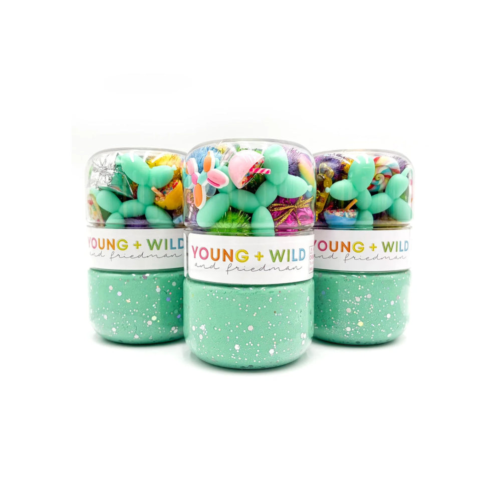 Three green jars with colorful contents and 'Young + Wild' label on a white background