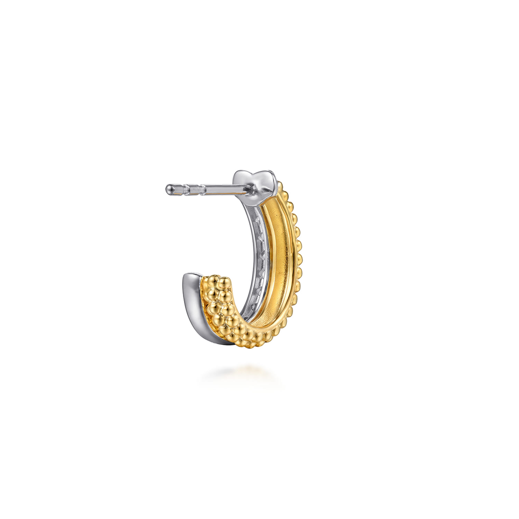 gold and silver hoop earring with clear stones on white background