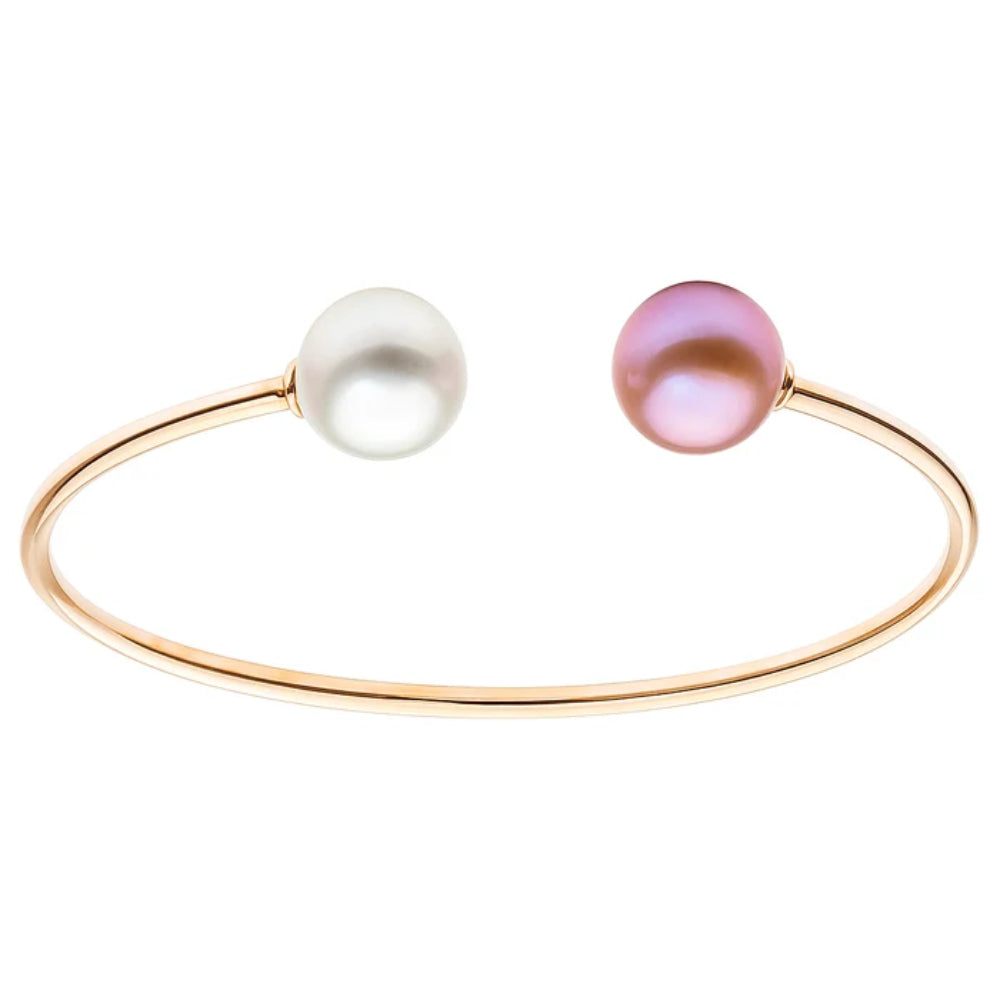 A delicate rose gold open cuff bracelet featuring two round pearls, one white and one iridescent pink, set against a plain white background.
