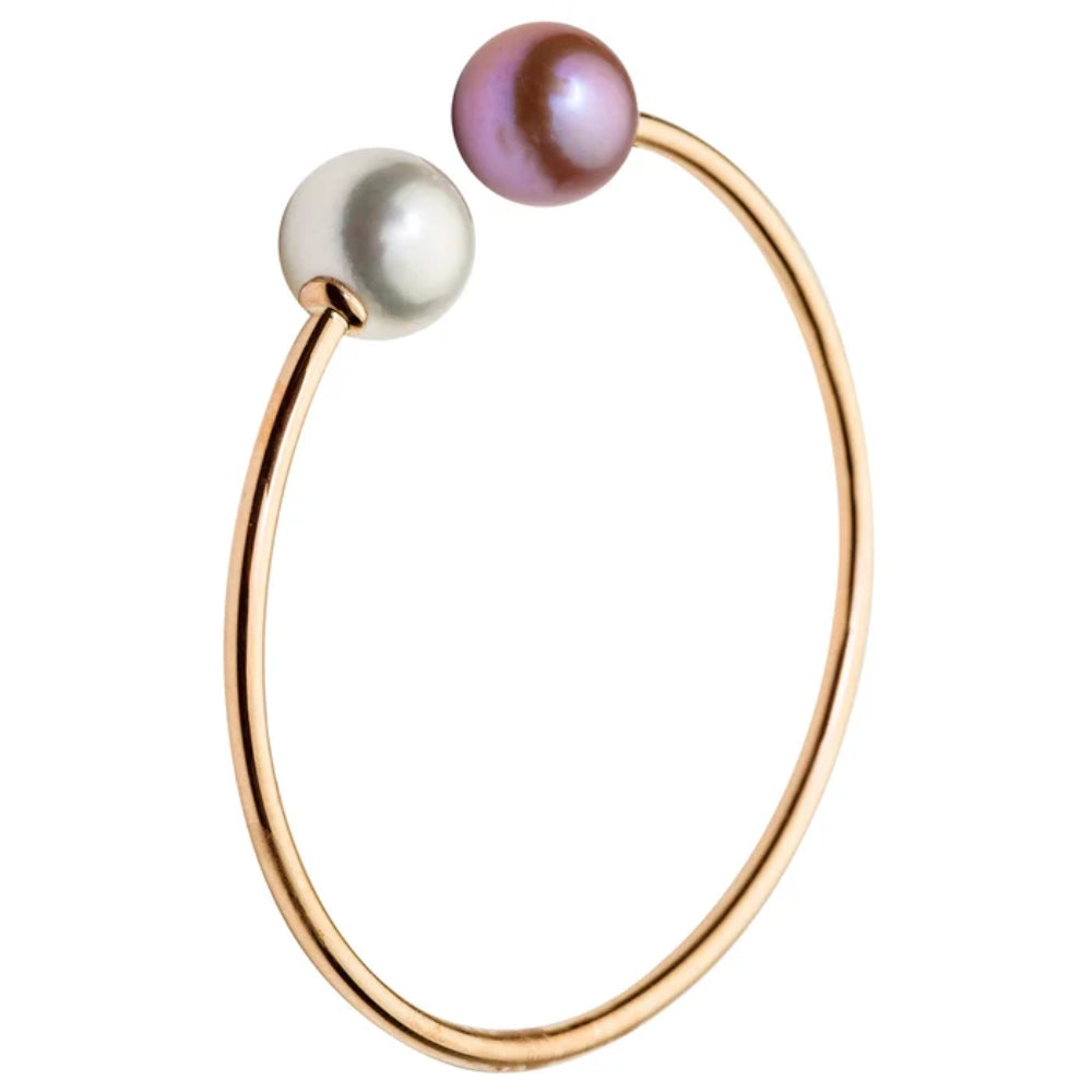 A minimalist open hoop ring in polished rose gold, featuring two spherical pearls at the ends, one white and one iridescent purple, set against a solid white background.