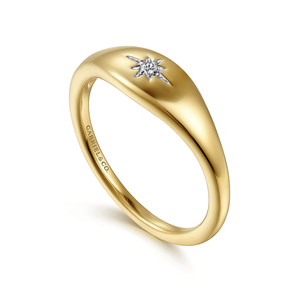 Gold ring with a diamond on a white background