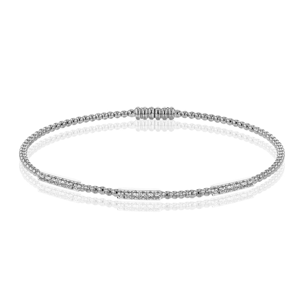 Silver bracelet with small diamonds on a white background