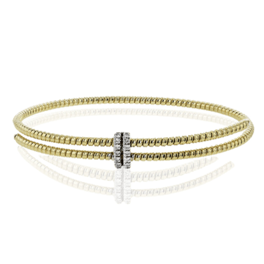 An 18k gold double row bangle bracelet with sparkling white diamonds in an elegant overlap design.