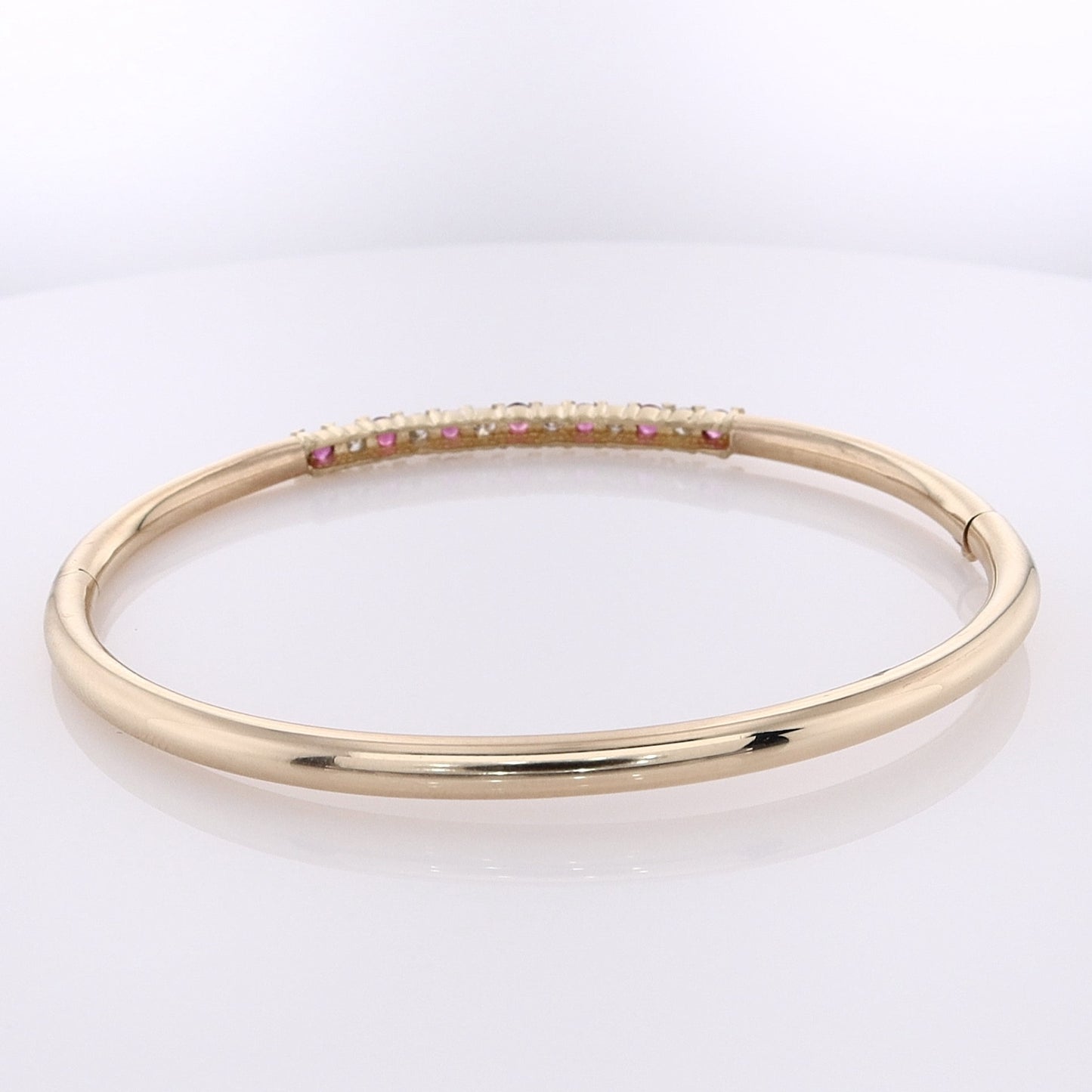 Estate 14 Karat Yellow Gold Alternating Diamond and Ruby Hinged Bangle Bracelet