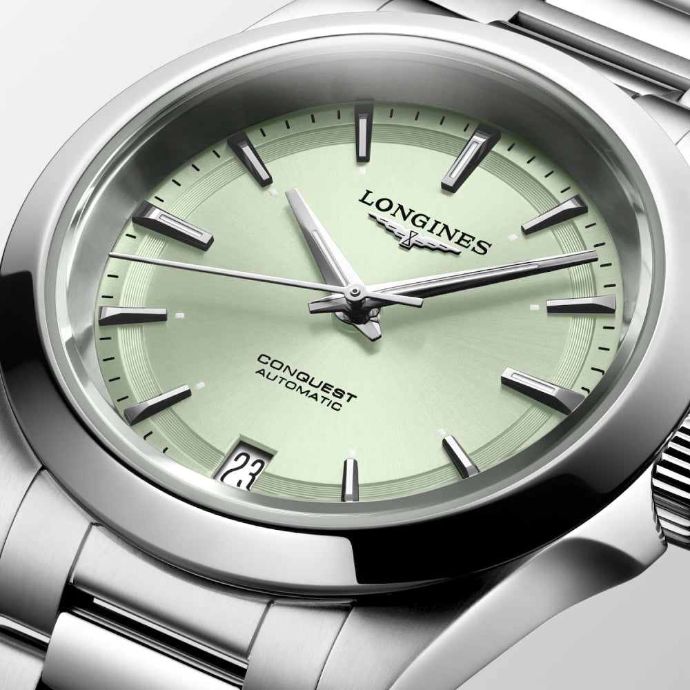 Longines watch with green dial and silver case on a white background