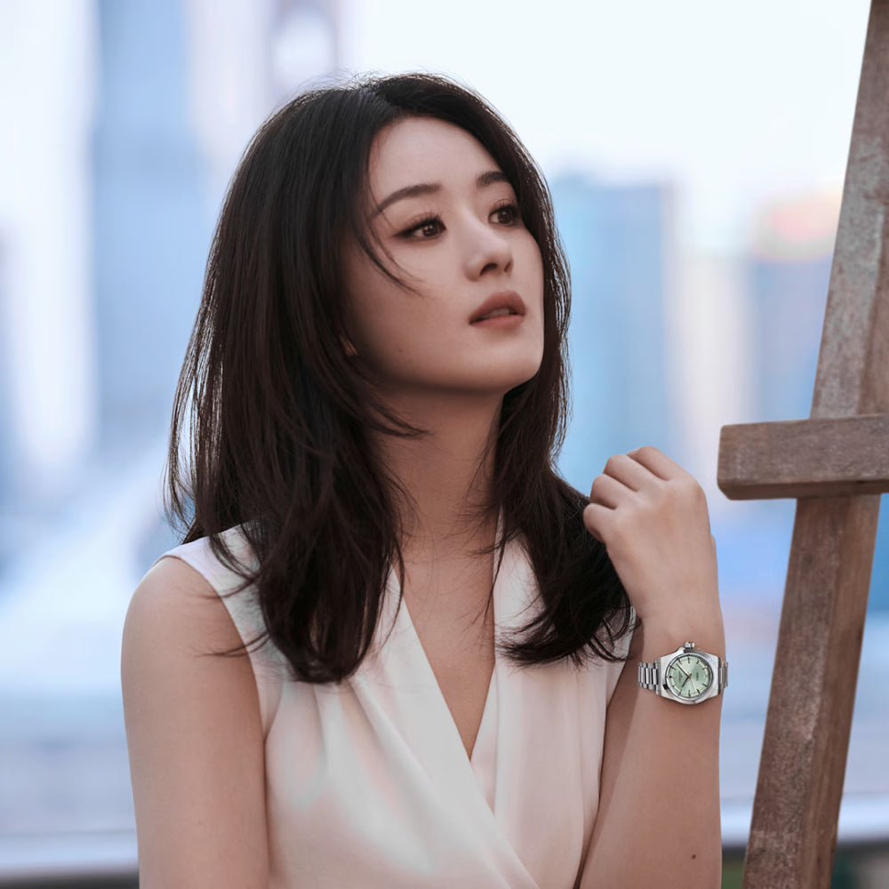 Woman wearing a watch with a blurred background