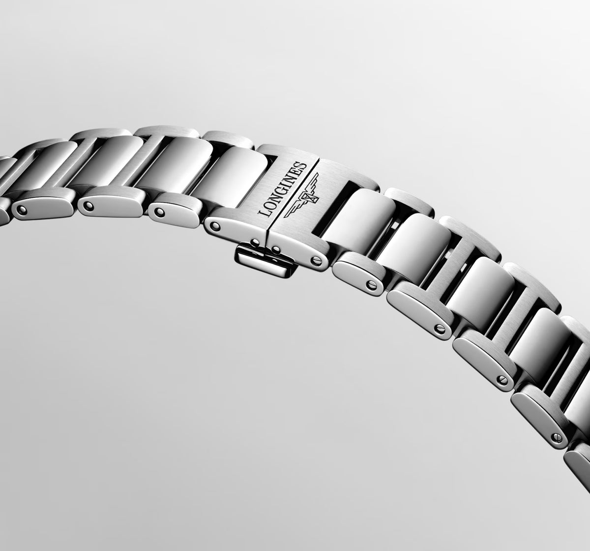 Two-tone metal bracelet with brand logo on a light gray background