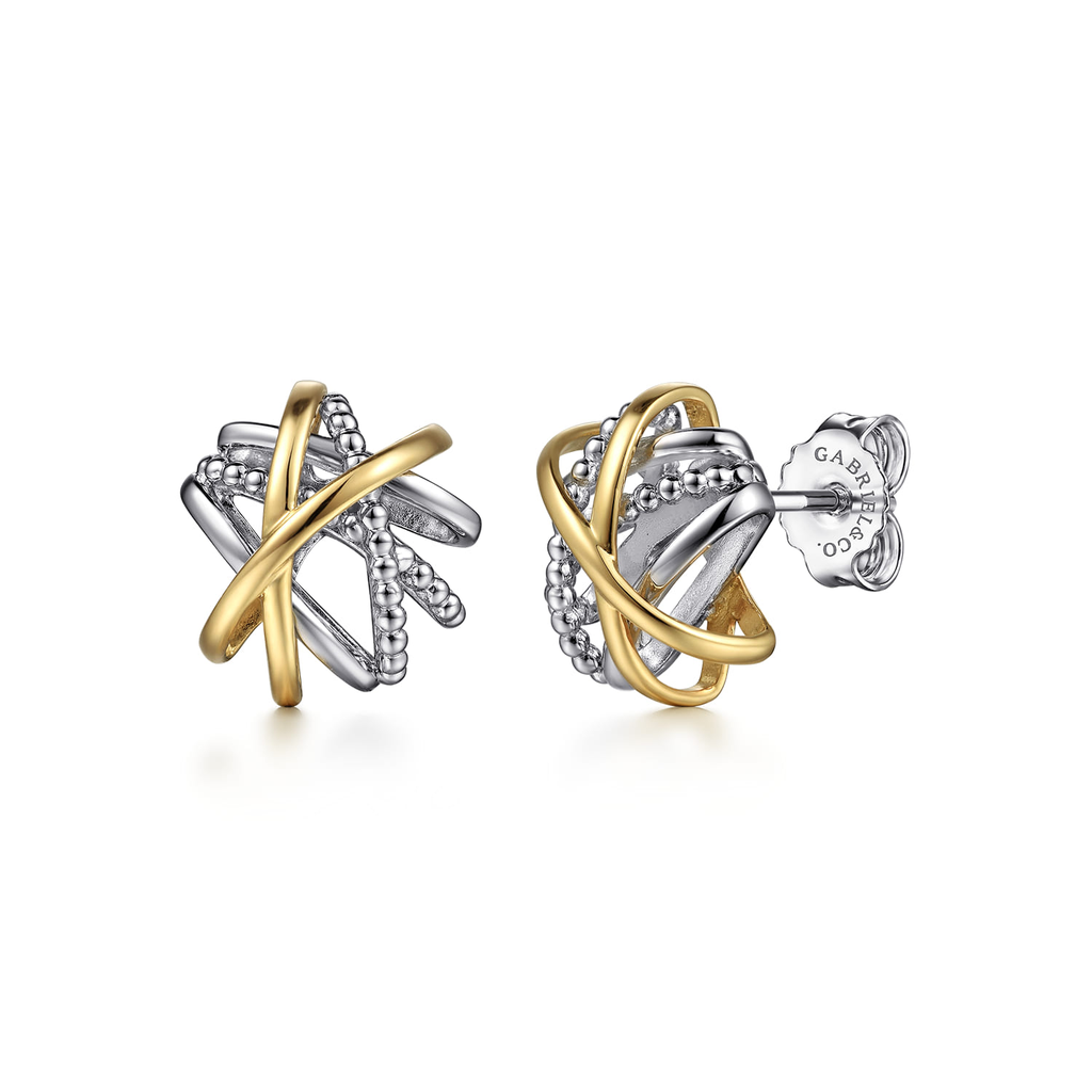 Pair of gold and silver earrings on a white background