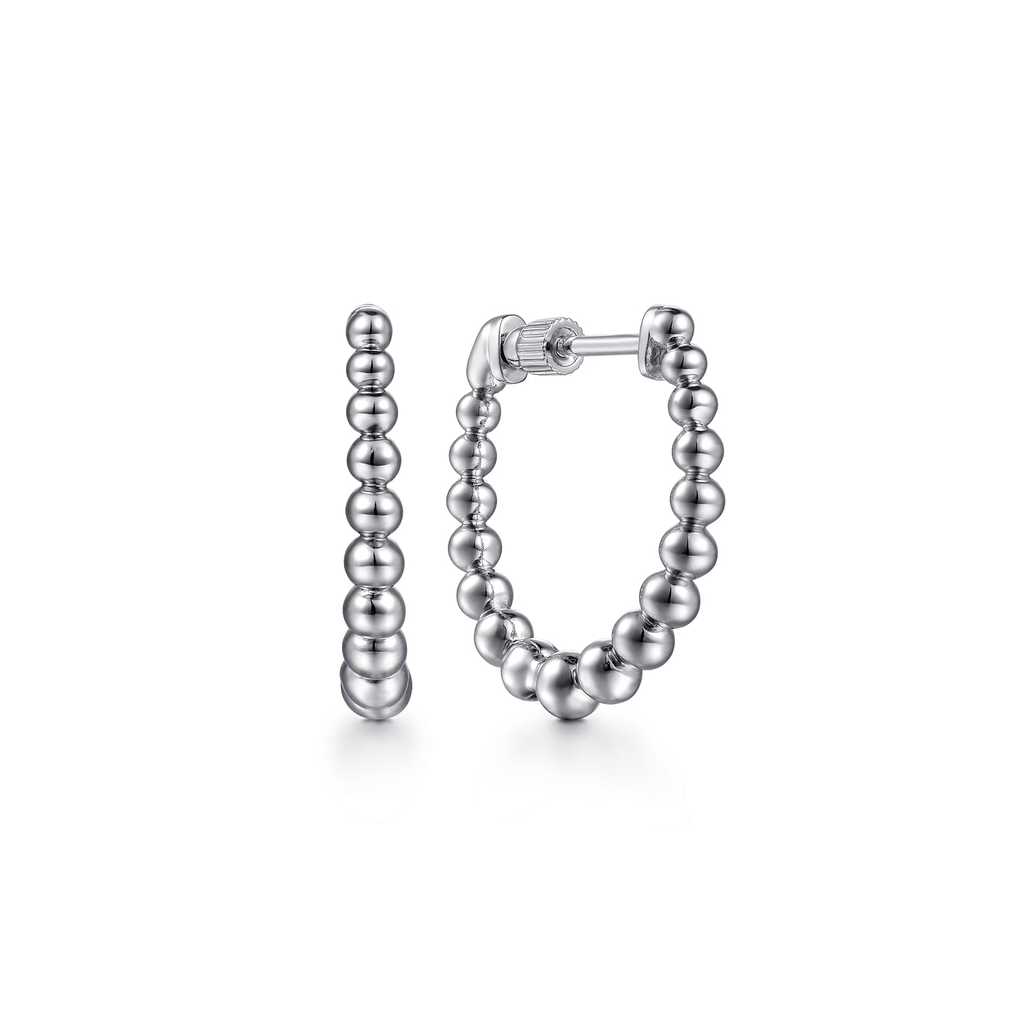 Silver beaded hoop earrings on a white background